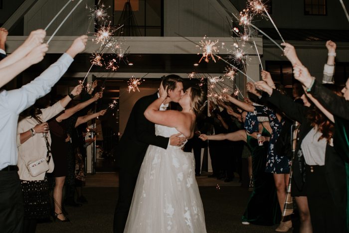 Bride And Groom In Sparkler Exit Wearing Chic Lace Wedding Dress Called Hattie Lane Lynette By Rebecca Ingram