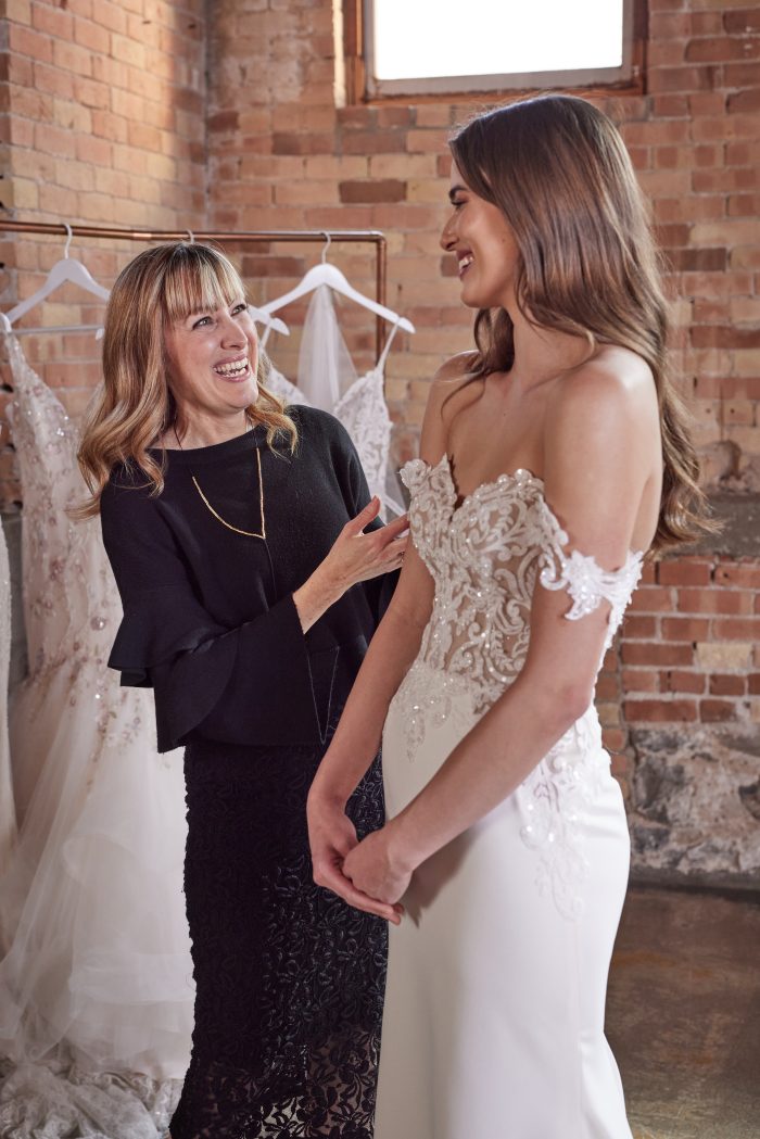 Bride picking out her dress during Cheer for Charity to double her impact.