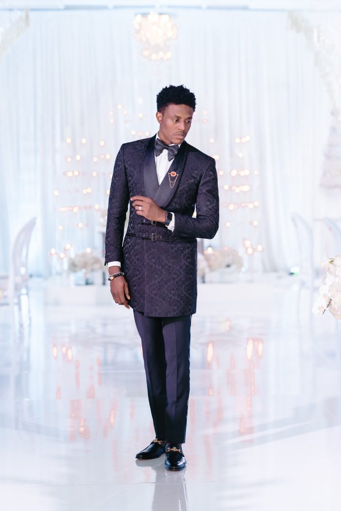 Groom Wearing Black Suit at a Luxurious Wedding