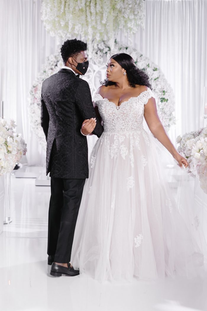 Groom Wearing a Mask with Curvy Bride Wearing Plus Size Princess Wedding Dress Called Natalie by Maggie Sottero