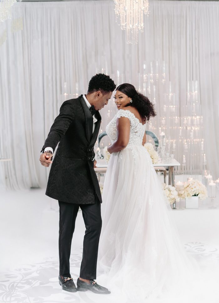 Groom Dancing with Bride Wearing Plus Size A-line Wedding Dress Called Natalie by Maggie Sottero