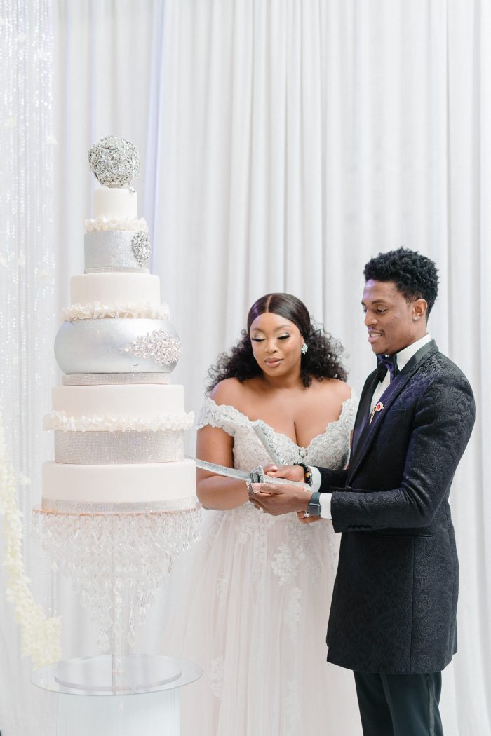 Bride and Groom Cutting Crystal and White Wedding Cake