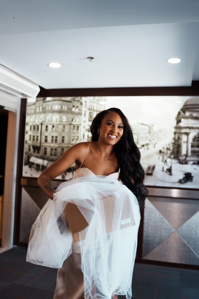 Bridesmaid carrying wedding supplies