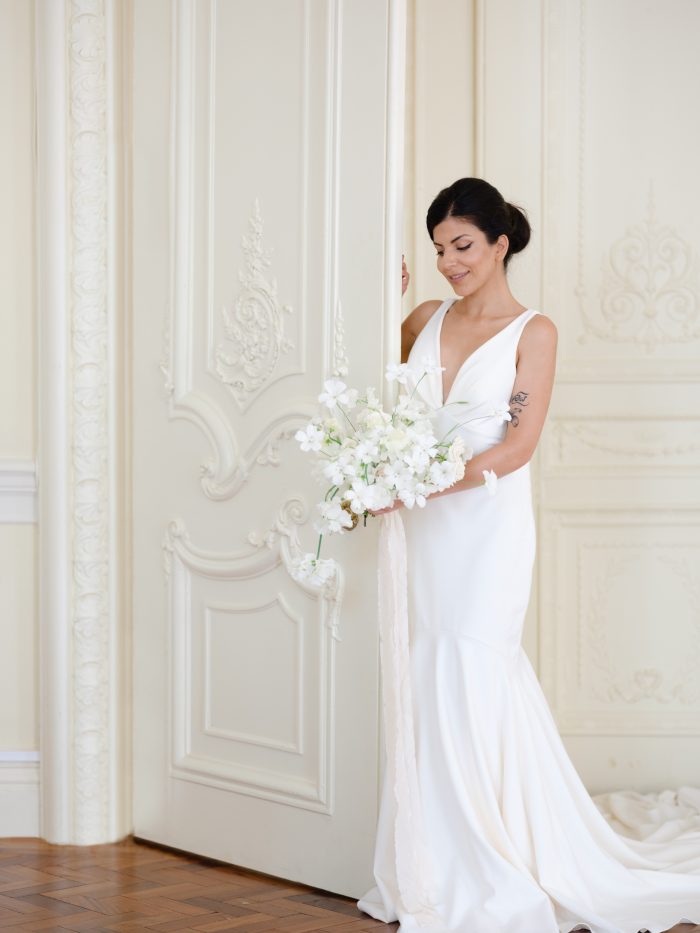 Woman In Wedding Dress Posing With Flowers