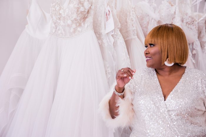 Black Owned Businesses Header Image With Black Retail Owner Standing In Front Of Maggie Sottero Wedding Dresses