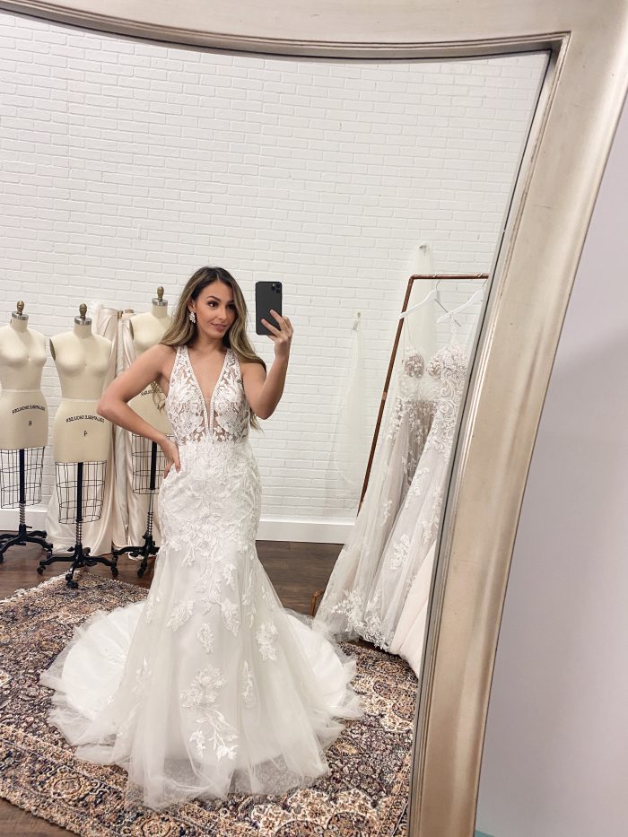 Bride Taking a Selfie in the Mirror During Her Wedding Dress FItting