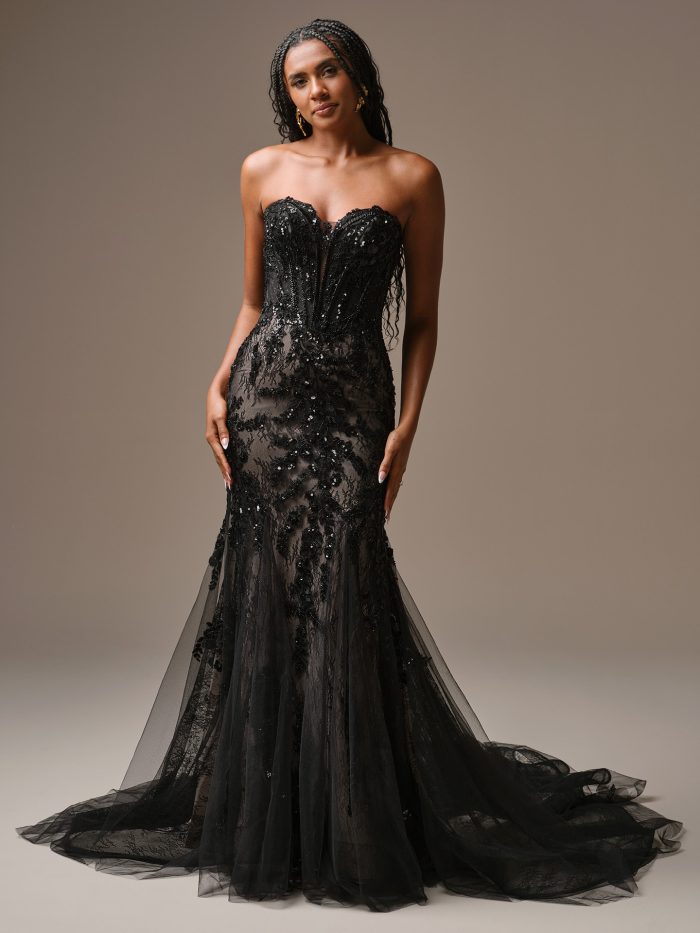 Bride wearing Benjie by Maggie Sottero, a strapless black fit-and-flare wedding dress with illusion lace, sequin embellishments, and dramatic tulle skirt.