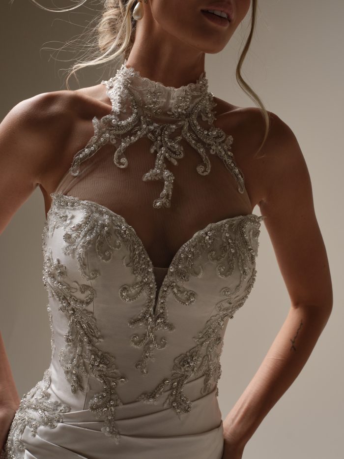 Close-up of the Maggie Sottero Cressida wedding dress showing the high-neck beaded detailing and intricately embroidered bodice.