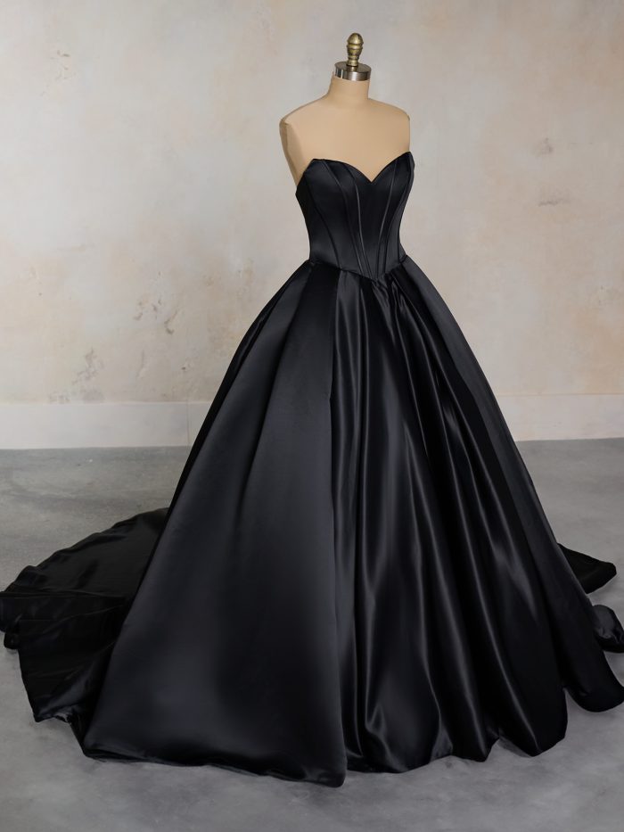 Derrick by Maggie Sottero, a strapless black ballgown wedding dress with sweetheart neckline, exposed boning bodice, and voluminous satin skirt with chapel-length train.