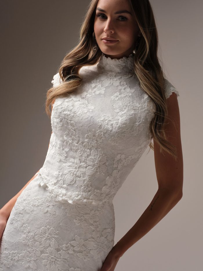 Devon jacket by Maggie Sottero, detachable high-neck lace bridal jacket featuring cap sleeves, floral lace detailing, and modest full-coverage bodice overlay.