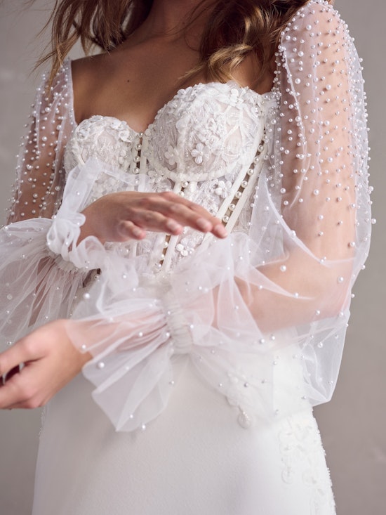 Bride wearing pearl sleeves with her sheath wedding dress