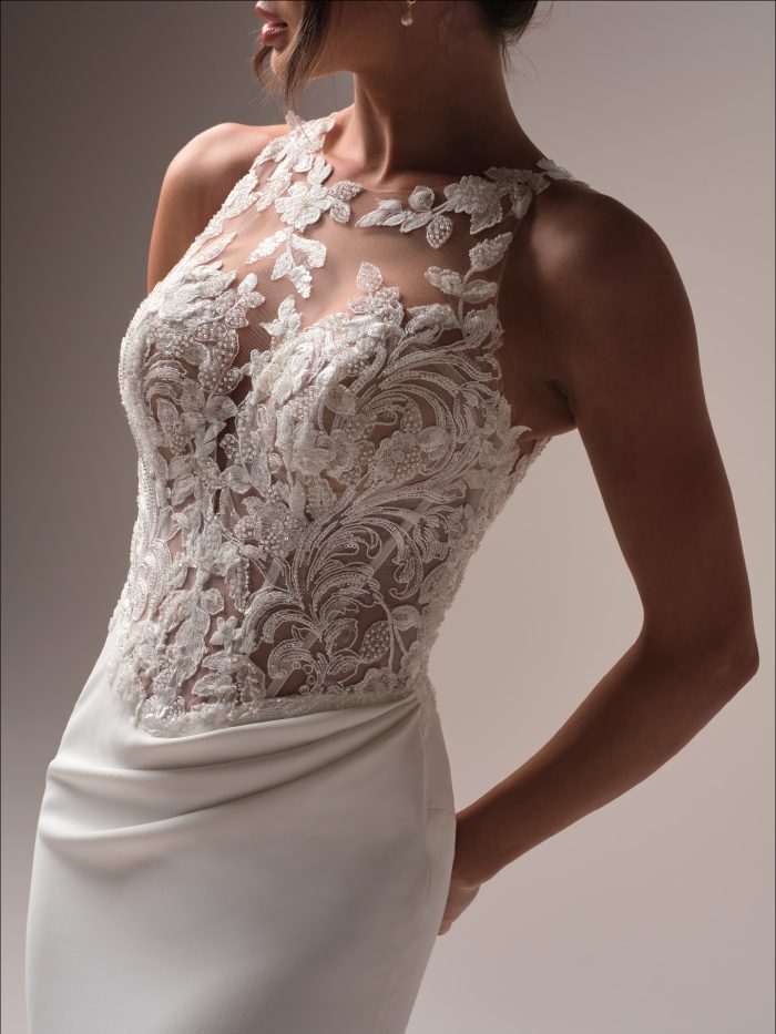 Bride wearing a sheath basque waist wedding dress with a high neckline