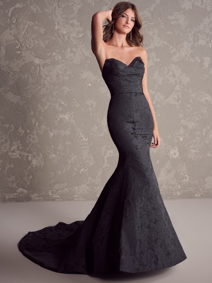 Full view of Hilo black jacquard fit-and-flare wedding dress by Maggie Sottero featuring strapless neckline, fitted silhouette, and dramatic chapel-length train.