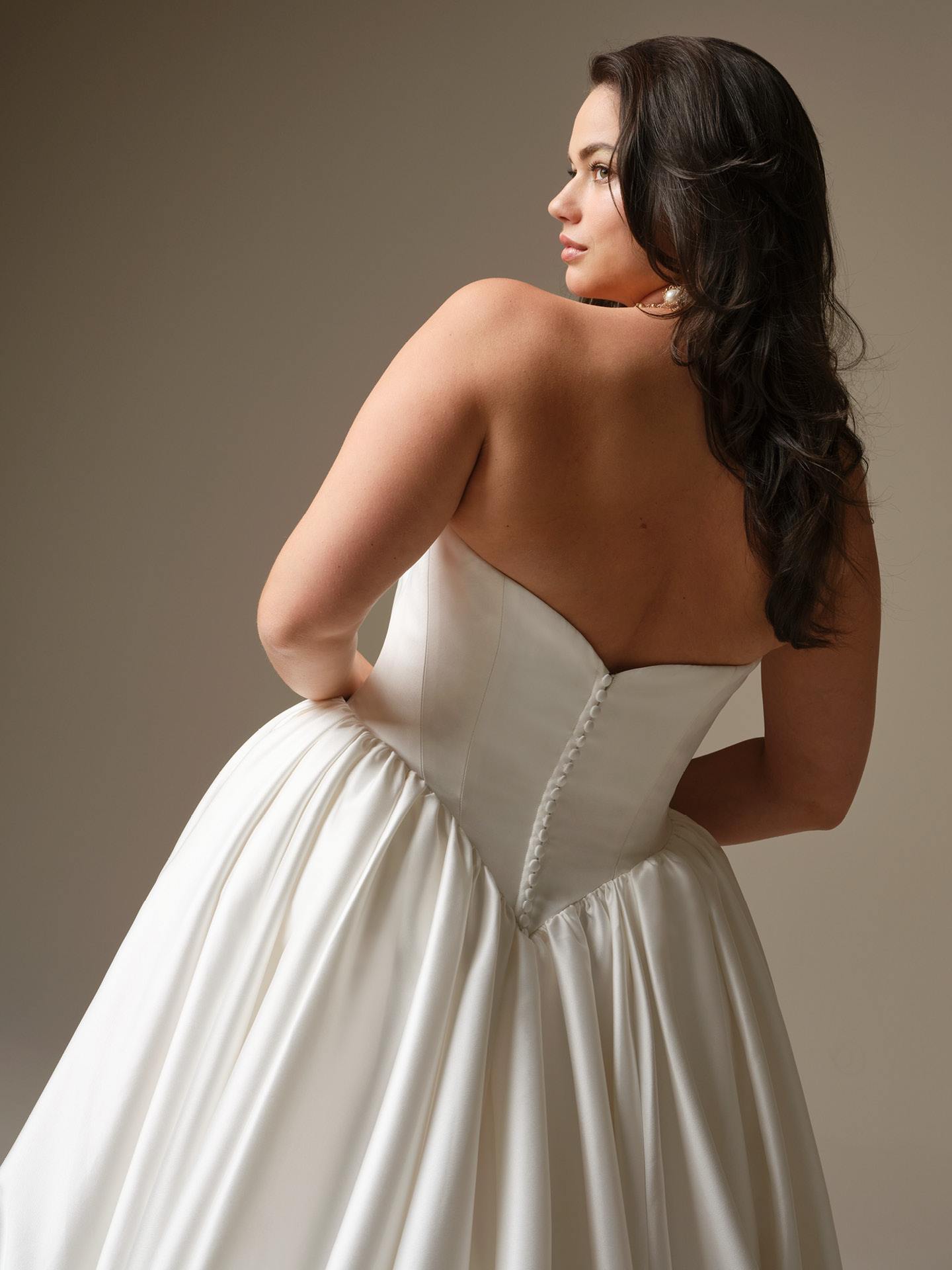 Hudson satin ballgown wedding dress with strapless neckline, Basque waist, covered button back detail, and voluminous satin skirt.