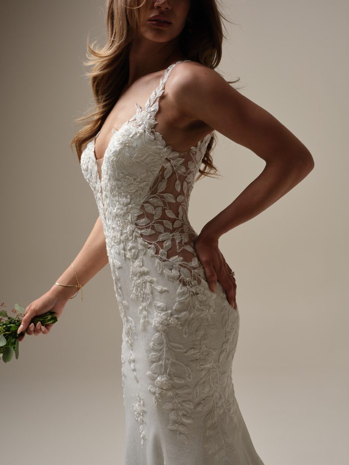 Close-up of the Keegan gown showing the illusion lace side cutouts, beaded lace straps, and intricate floral detailing that accentuate the glittering tulle fabric and fitted silhouette.