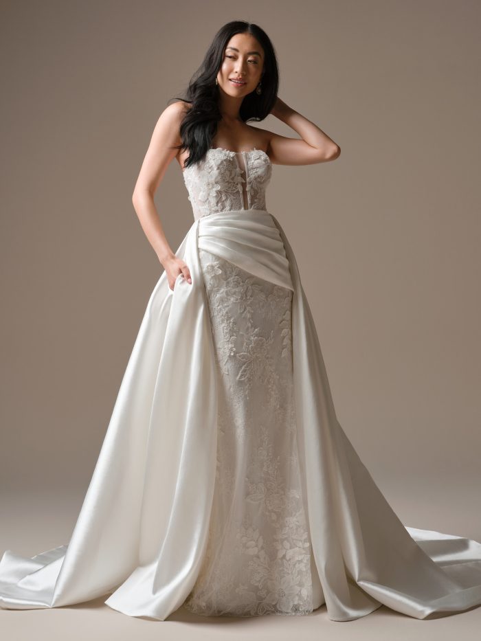 Bride wearing satin detachable overskirt with a ruched front and long train