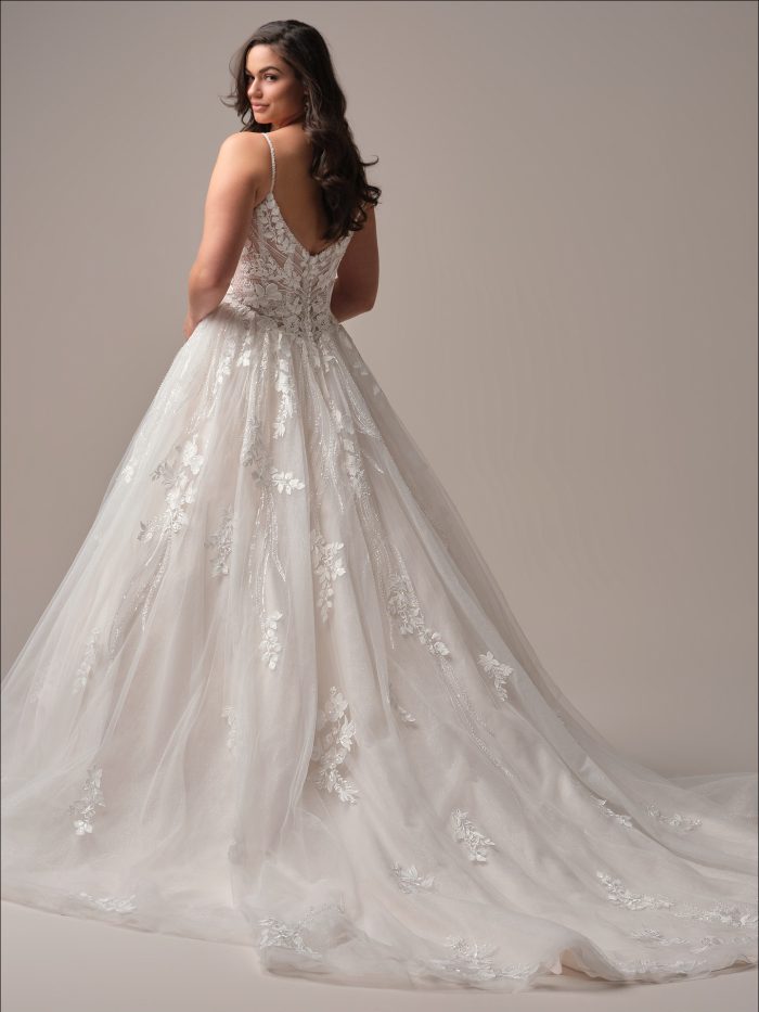 Back view of Liberty by Maggie Sottero featuring a plunging illusion lace V-back, beaded straps, and flowing sparkle tulle skirt with lace appliqués.