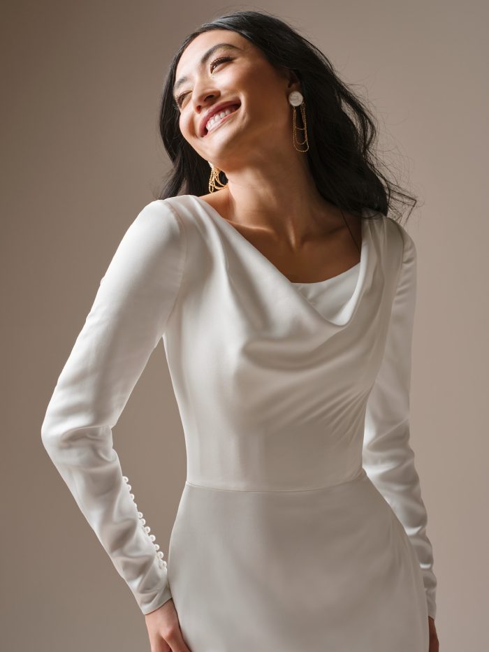Melinda satin sheath wedding dress with draped cowl neckline, long sleeves, and minimalist vintage-inspired design.