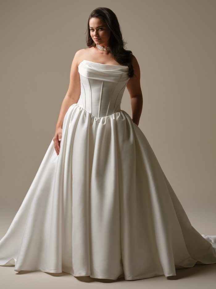 Front view of the Yuma wedding dress featuring a draped strapless neckline, structured corset bodice, and a full ballgown skirt.
