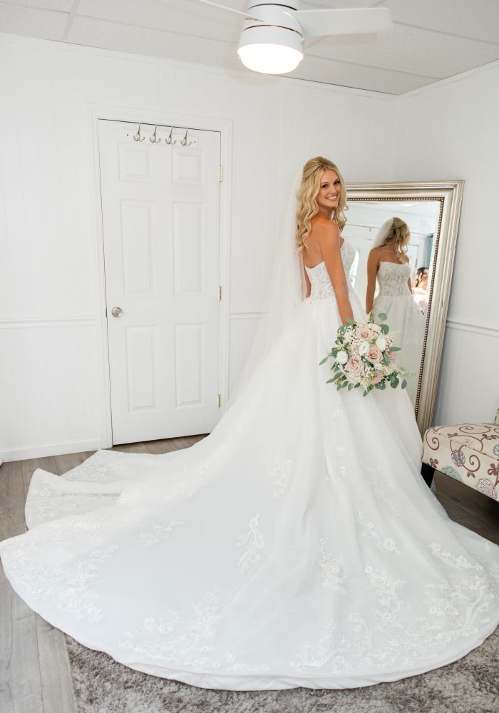 Bride wearing Norvinia wedding dress by Sottero and Midgley
