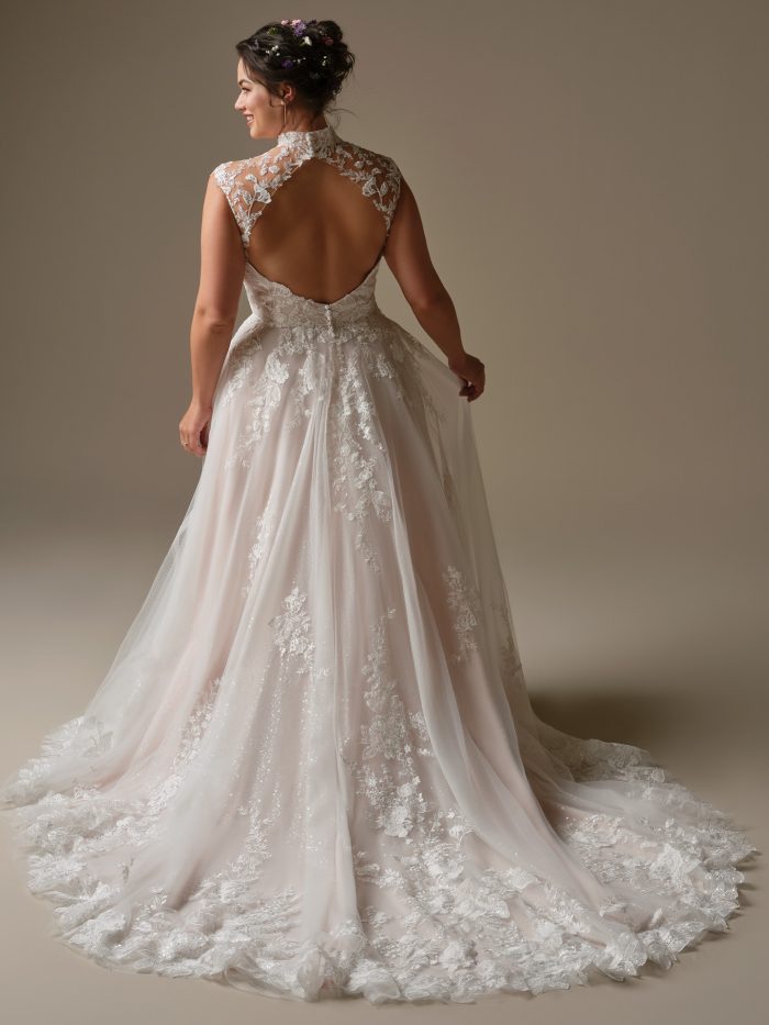 Back view of Cody by Rebecca Ingram featuring an illusion lace bodice with keyhole back, sequined lace details, and soft A-line skirt with lace appliqués.