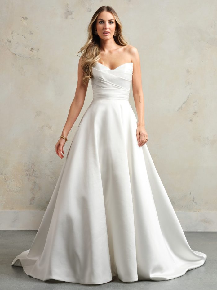 Bride wearing the full-length Ethelinda wedding dress, showcasing the strapless sweetheart neckline, ruched bodice, and smooth satin A-line skirt with a classic, elegant finish.