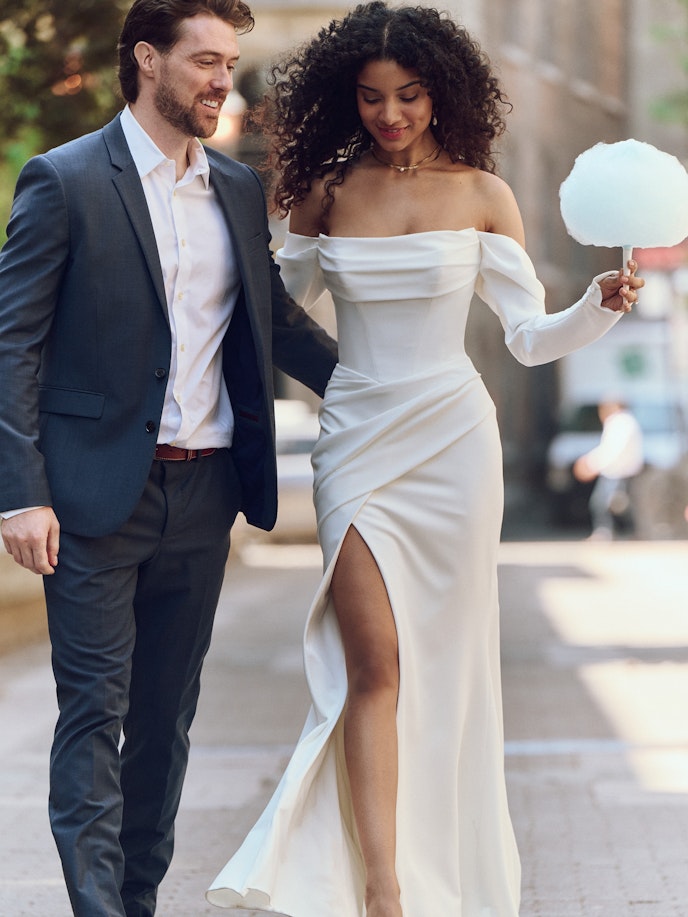 Bride wearing long sleeve sheath wedding gown