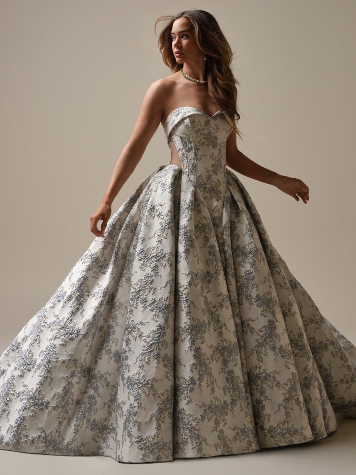 Sottero and Midgley Aberdeen ballgown wedding dress in silver-blue jacquard, featuring a strapless neckline, full structured skirt, and romantic metallic floral brocade pattern.