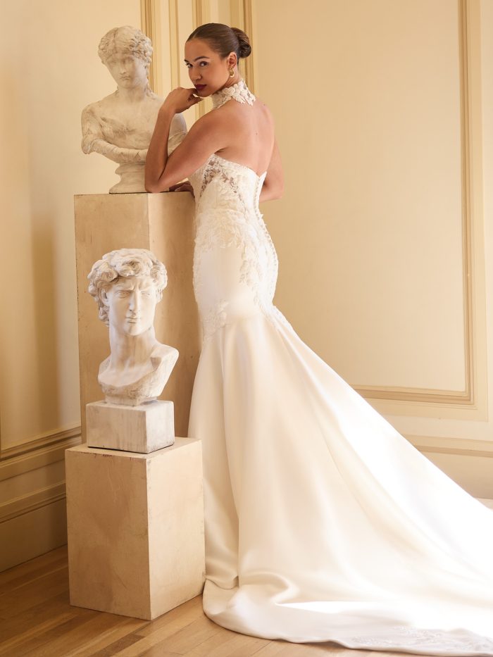 Back view of the Sottero and Midgley Burke bridal gown showing the strapless fit, lace-accented back, and sweeping satin train for a sleek, modern finish.