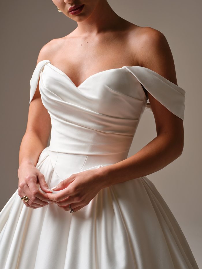 Close-up of Elias by Sottero & Midgley featuring a softly draped satin bodice and elegant off-the-shoulder sleeves