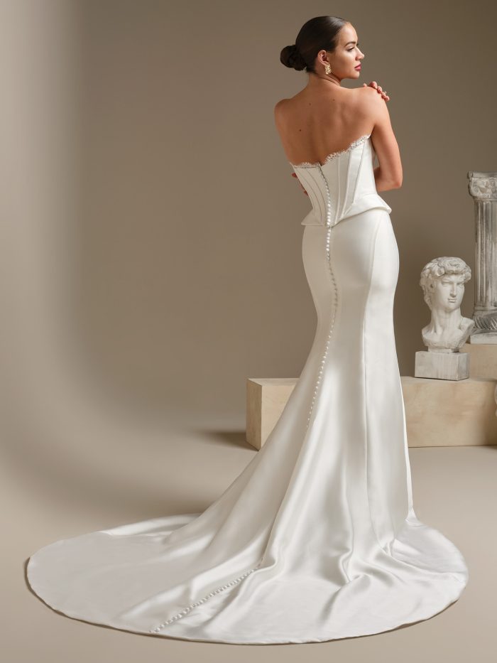 Back view of Lassen Marie by Sottero & Midgley featuring a strapless corset bodice, covered button back, and sleek satin train