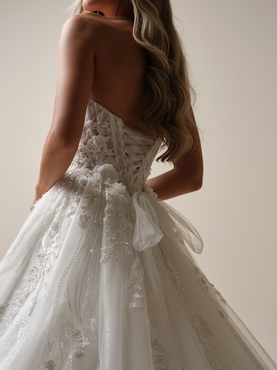 Bride wearing a lace up corset wedding dress with a large tulle bow