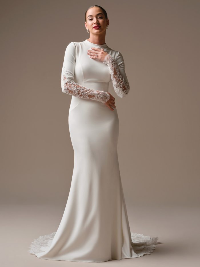 Sottero and Midgley Lovai sheath wedding dress with long lace sleeves, high neckline, and fitted silhouette