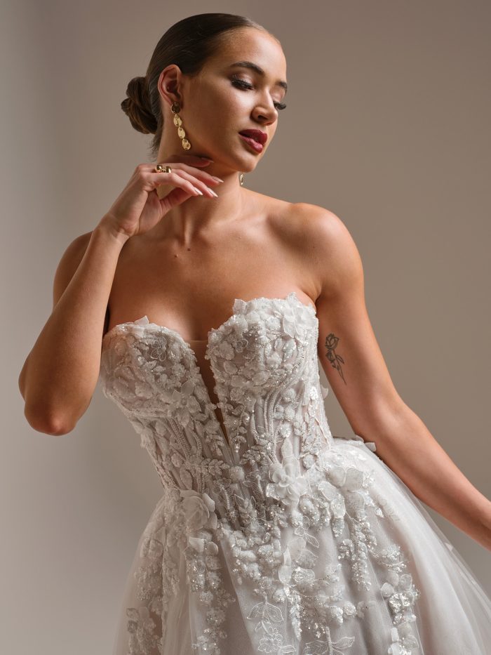 Close-up of the Twilight Lane wedding dress highlighting the embellished sweetheart bodice with intricate 3D beaded lace, sculpted corsetry, and delicate floral details for regal glamour with a boho twist.